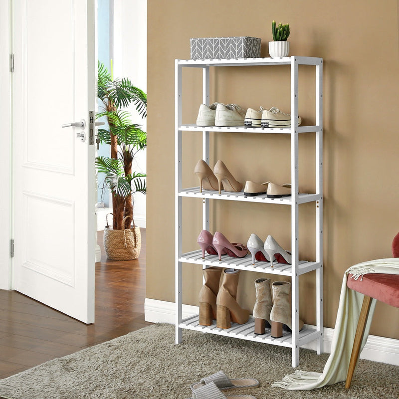 White bamboo shelf used as a hallway shoe rack beside the front door
