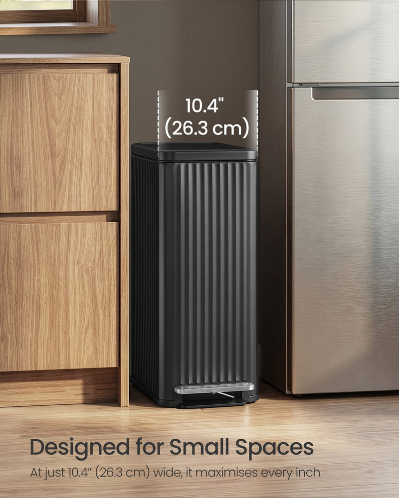 The black bin standing in a narrow gap between a kitchen cabinet and a fridge