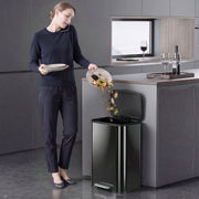 Woman scraping food waste into the Homcom pedal bin with the lid open