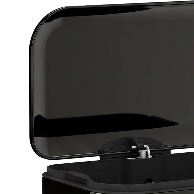 Close-up of the open black lid and hinge on the pedal bin