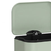 Close-up of the open light green lid and hinge on the pedal bin