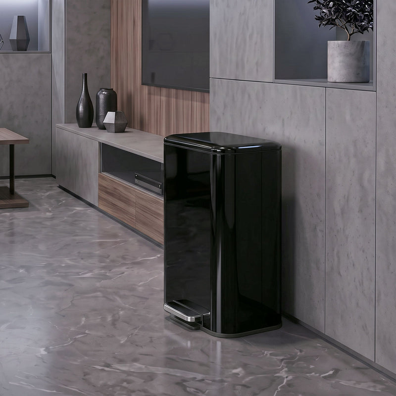 Black 50L pedal bin standing beside a TV unit in a living room