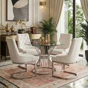 Clear glass round dining table with silver hourglass base styled with dining chairs