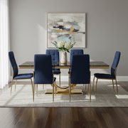 Black faux marble dining table with brushed gold pedestal styled with dining chairs