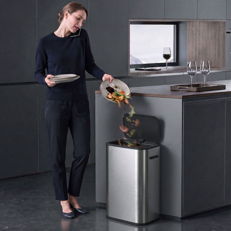 Woman scraping food scraps into the open HOMCOM sensor bin in a modern kitchen