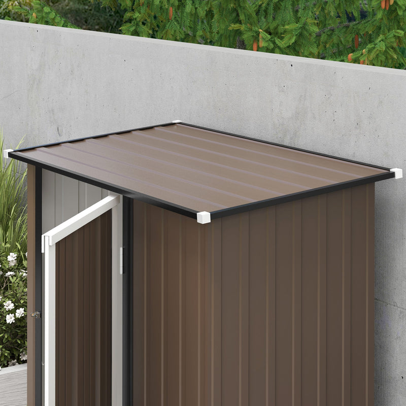 Overhead view of the single-slope pent roof on the brown shed with the door open below