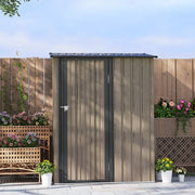 Closed light grey shed against a wooden fence with planters and flowers around it