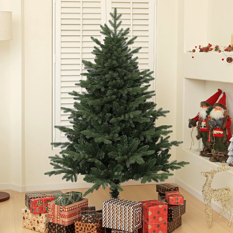 Front view of the bare 5ft spruce Christmas tree with presents and a Santa figure beside it