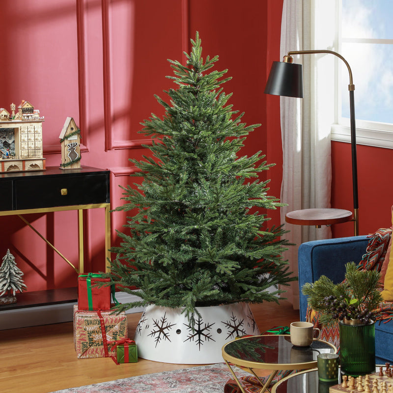 Bushy green Christmas tree in a red living room with a white tree skirt and wrapped gifts