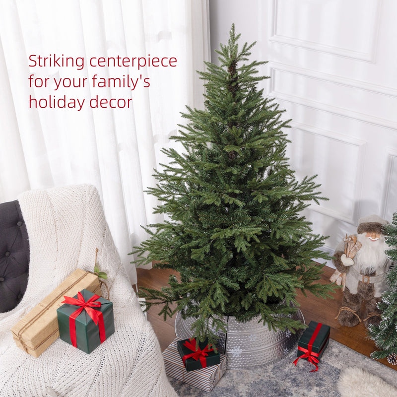 Green Christmas tree in a silver tree skirt beside an armchair with a striking centrepiece caption