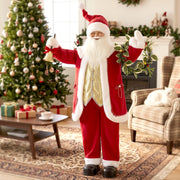 Santa Claus figure waving beside a Christmas tree in a living room