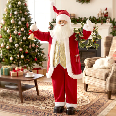 Santa Claus figure waving beside a Christmas tree in a living room