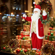 Santa figure in a window display surrounded by gifts and wreaths