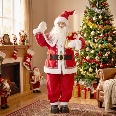 Singing Santa Claus figure waving beside a decorated Christmas tree