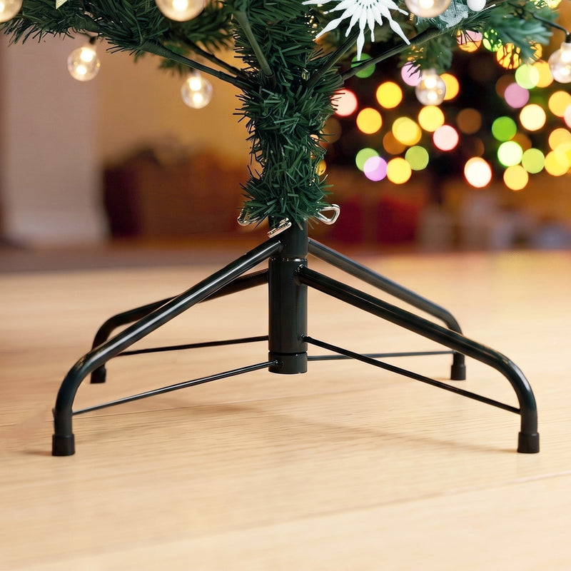 Close-up of the black folding metal stand and trunk of the tree