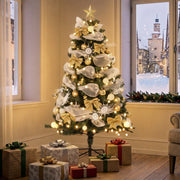 Lit decorated tree in a corner by a window with wrapped gifts on the floor