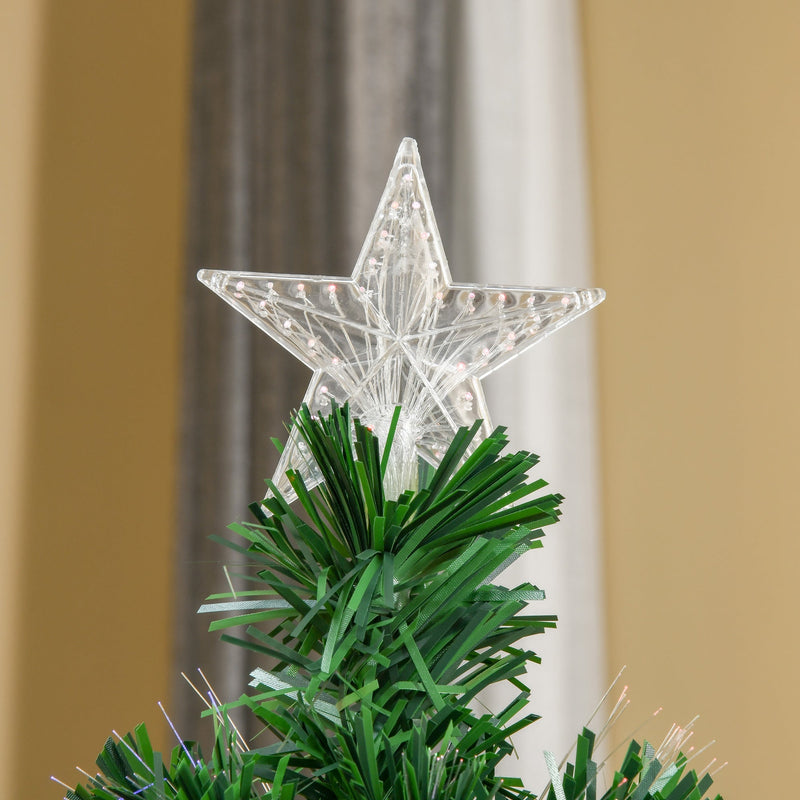 Close-up of the clear star topper above the green branches