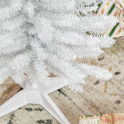 Close-up of white branch tips and plastic base legs on a patterned rug