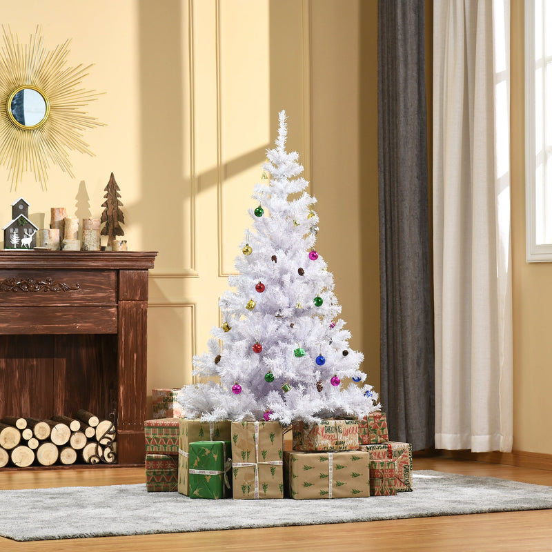 White Christmas tree in front of a fireplace with stacked wrapped presents