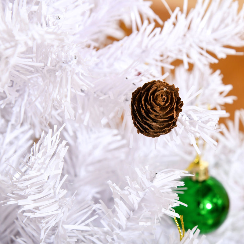 Close-up of a pine cone and a green bauble on white branches