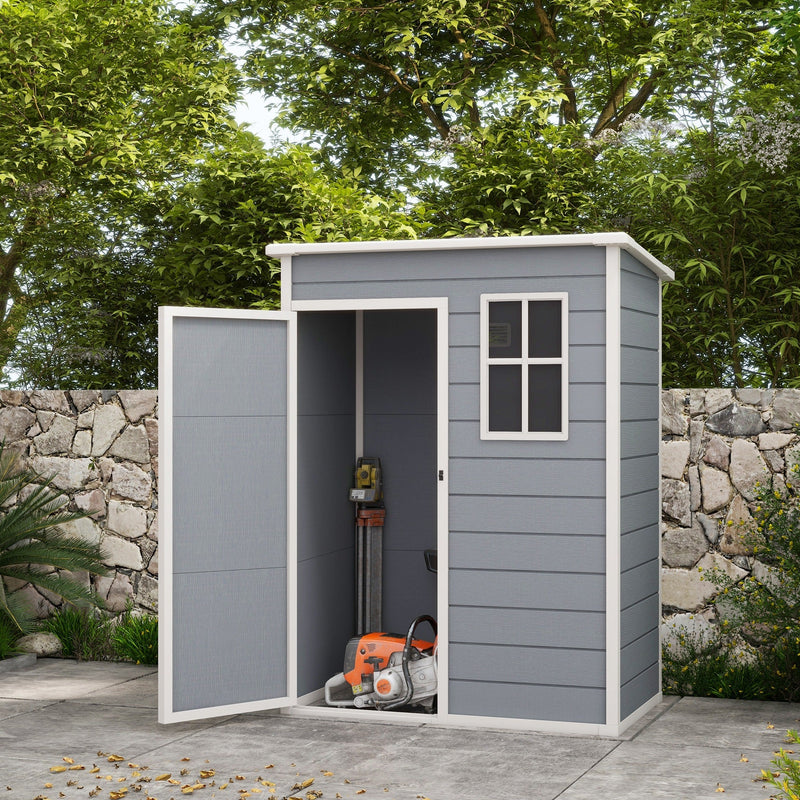 5x3ft grey plastic shed on a patio with its door open and garden power tools inside