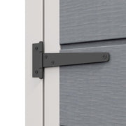 Close-up of the long black door hinge bolted to the grey wall panel of the shed