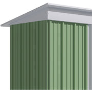 Rear three-quarter view of the green shed showing the plain back panels and the slope of the lean-to roof