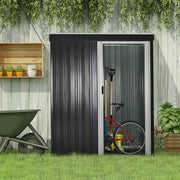 Black metal shed against a garden wall with a bike, spade and wheelbarrow beside it