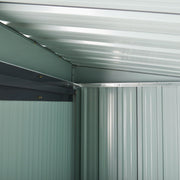 Inside the shed showing the pale galvanised ceiling panels and sloping roof beam