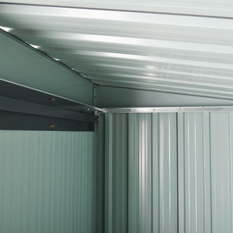 Inside the shed showing the pale galvanised ceiling panels and sloping roof beam