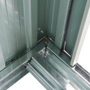 Close-up of the shed corner joint where the wall panels bolt to the galvanised base frame