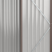 Close-up inside the shed door showing the pale interior lining and diagonal reinforcing brace