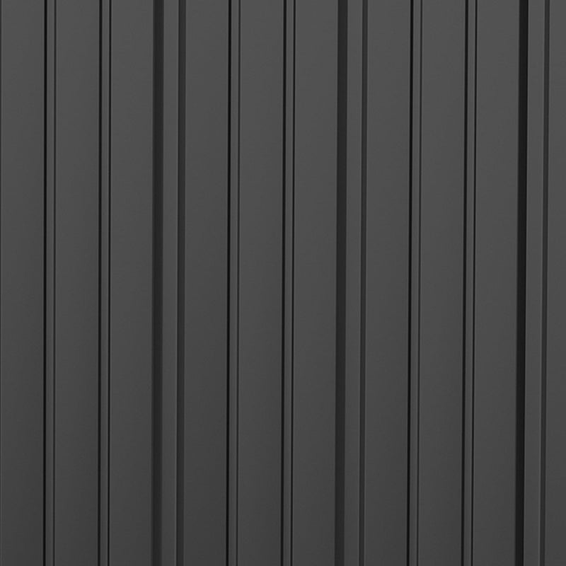 Close-up of the ribbed dark grey steel wall panels and vertical seam of the shed