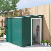 Green lean to metal shed standing against a timber fence with the end sliding door open, showing tools stored inside