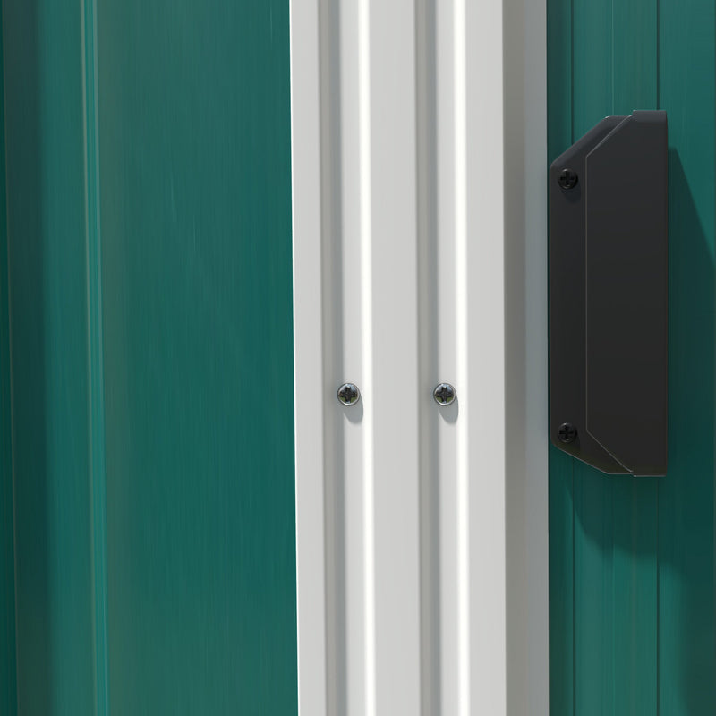 Close-up of the sliding door edge and the black door handle on the green steel end wall