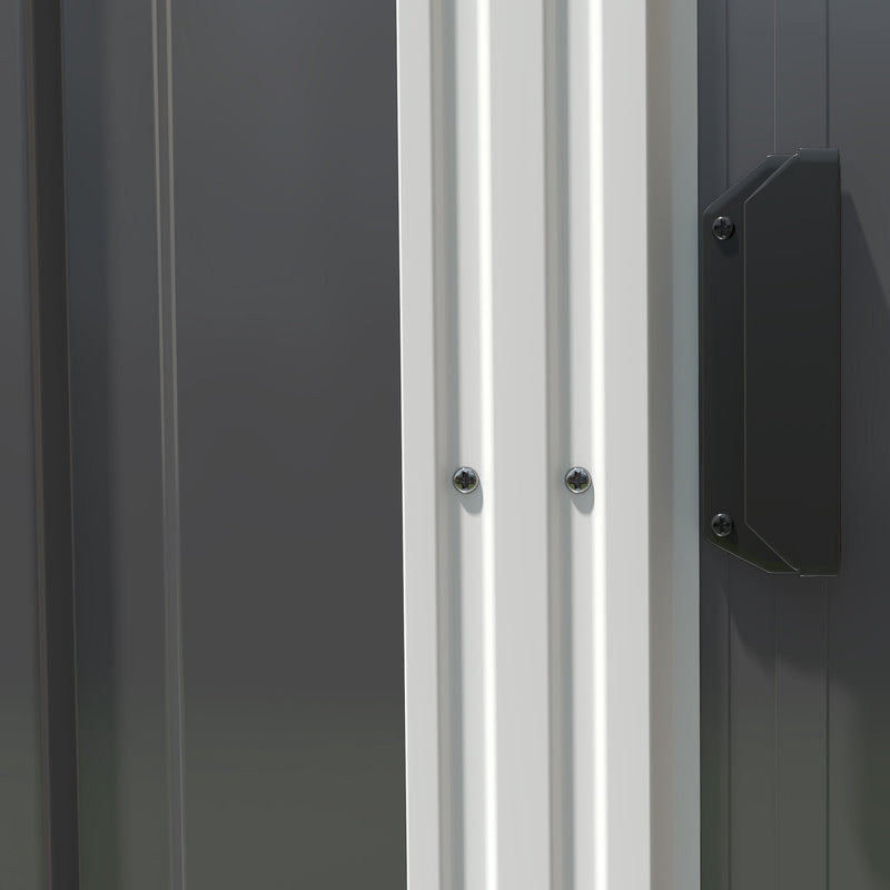 Close-up of the dark grey shed's sliding door edge, white frame trim and fixing screws