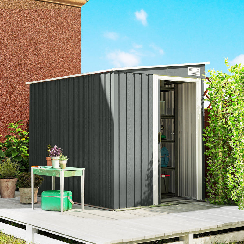 Grey metal shed on decking with the sliding door open and pot plants beside it