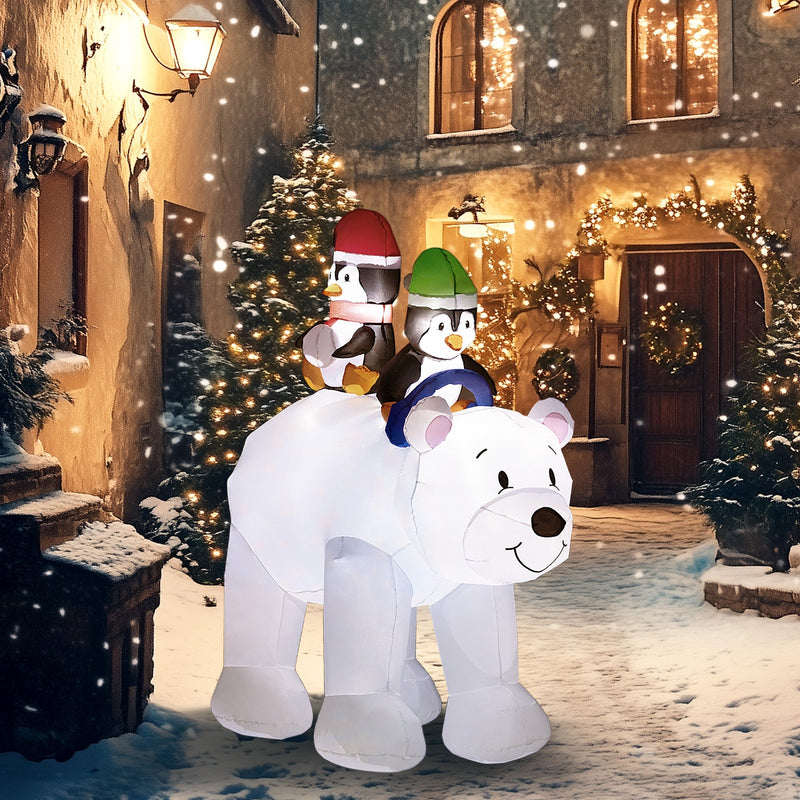 Glowing polar bear and penguins inflatable in a snowy lantern-lit street at night