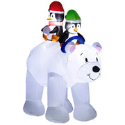 Inflated white polar bear carrying two penguins in red and green hats on a plain background