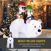 Lit polar bear and penguins in a snowy street with a built-in LED lights caption