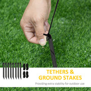 Eight ground stakes and four tethers, with a hand attaching a tether to a stake on grass