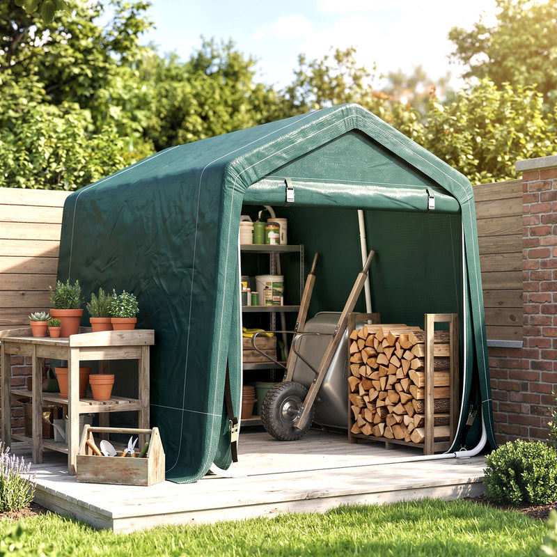 Green shed storing plant pots, a wheelbarrow, firewood and garden tools
