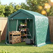 Green shed in a garden with plant shelves and a firewood rack inside