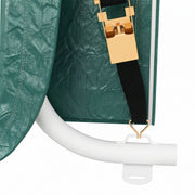 Close-up of the strap and clasp fastening on the green shed cover