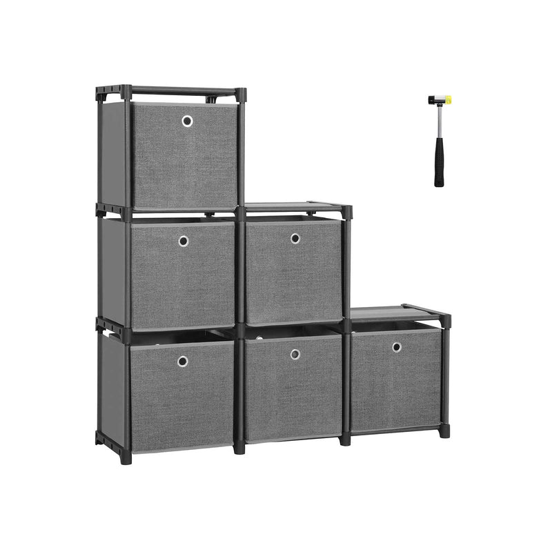 Black-framed 6-cube storage unit built in a step shape with six grey fabric boxes and a rubber mallet