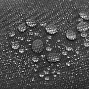 Close-up of water droplets beading on the dark fabric surface of a storage box