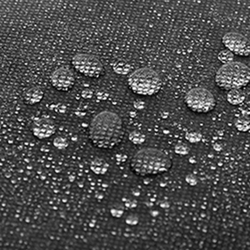 Close-up of water droplets beading on the dark fabric surface of a storage box
