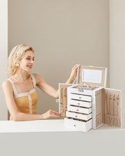 Woman lifting the lid of the white 6-tier jewellery case on a dressing table