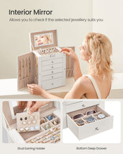 Woman checking her reflection in the lid mirror, with the stud earring holder and deep bottom drawer