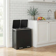 Bin in a tiled kitchen with both lids open beside a countertop with fruit